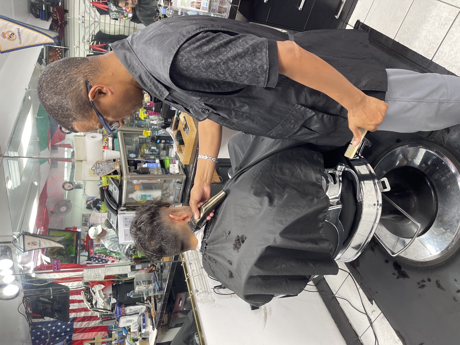 A barber lining up a cut with clippers